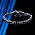 Minimalist 2mm moissanite tennis bracelet in sterling silver on a black reflective surface - 14cm / Moissanite Style / Silver