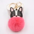 Close-up of bulldog leather charm with pink faux fur pom-pom and gold metal hardware - Watermelon red