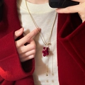Close-up of red flocked grape tassel necklace on a dark red winter wool coat - Gold Necklace-Red Grape Pendant