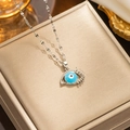 Detailed shot of a silver titanium steel necklace with a micro-paved evil eye pendant - 315 Steel-colored Eyelashes