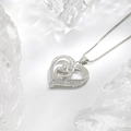 Silver mother and child heart necklace with sparkling crystals on icy background - Silver