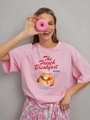Pink oversized cotton T-shirt with French Breakfast print worn by a smiling model - S / Pink