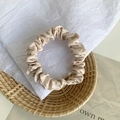 Elegant champagne gold satin scrunchie with a glossy silk-like finish and soft pleats - Light Camel