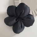 Detailed view of a black silk flower hair scrunchie on a white ceramic plate backdrop - Five-Petal Scrunchie - Black (Standard)