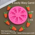 Macro detail of a 8-cavity carrot silicone mold with finished orange resin samples - Wave Carrot / Pink