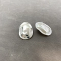 Macro shot of silver irregular pebble earrings with a polished metallic finish on grey - Stud Pin Style / Silver Needle
