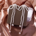Detail view of pearl bow earrings with long tassels on elegant silk background - 3244-Extra Long Pearl Bow Tassel