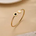 Brazalete abierto dorado de acero inoxidable con ojo turco y grabados de números romanos - Dorado - Números Romanos Concha