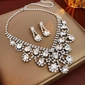 Macro shot of silver-colored rhinestone necklace and earrings set on a jewelry box - Necklace-Silver (Two-Piece Set)