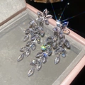 Macro view of silver floral earrings with crystal leaf tassels in a pink jewelry box - 88# Silver Needle - Silver In Color.