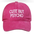 Close-up of 'CUTE BUT PSYCHO' white embroidery on hot pink cotton baseball cap - One Size / Rose Red