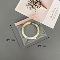 Pink zip-lock 11x11cm EVA jewelry pouch with green jade bangle for dustproof storage - 50 Silk Pink Transparent Zipper Bag / 11x11cm