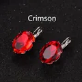 Silver-plated hook earrings with large oval red zircon stones on a black texture - Red