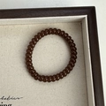 Coffee brown spiral hair tie with telephone cord design in a wooden display tray - Dark Coffee