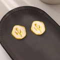 Vintage style tulip flower enamel earrings in gold hexagonal frames on grey leather - Large Tulip Enamel / Gold