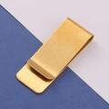 Macro shot of gold brushed stainless steel money clip on blue and white background - Brushed Gold Money Clip