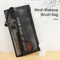 Black mesh makeup brush bag featuring decorative ribbon with Make Up Artist text - Mesh Makeup Artist Bag