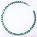 Detail of luxury emerald flower necklace with continuous floral links and crystal accents - Platinum Green Zirconia Necklace (VL526)