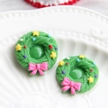 Detailed macro view of resin Christmas wreath charms with pink bows for DIY crafts - Star Wreath