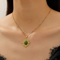 Golden necklace with sunburst pendant and green oval gemstone shown on model neck - Gold Green Gemstone Sunburst Necklace Style (S69)