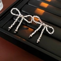 Silver bow-shaped earrings with square chain texture and bead charms on a black tray - Earrings (with 925 Silver Pin) / Silver