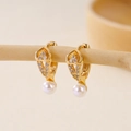 Macro shot of gold-plated pearl drop earrings with white zircon accents on wood display - Exquisite Pendant Hoop Buckle (EH412010)