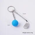 Mini silver golf club keychain with blue textured golf ball charm for bags and keys - Light Blue Golf Ball + Club