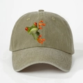 Close-up of a 3D red-eyed tree frog embroidery on a vintage olive washed cotton baseball cap - Khaki