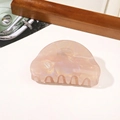 Close-up of pink pearlescent PVC hair claw clip with marble texture on marble surface - PVC 8cm Round Head - Iridescent Orange