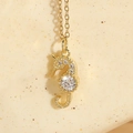 Golden seahorse necklace pendant featuring sparkling white zircon and crystal inlay - Seahorse