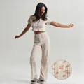 Women's floral pointelle pajamas set featuring button-up short sleeve top and long pants - S / Cream Floral