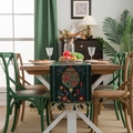 Dark green Christmas table runner with red floral jacquard and festive fringe tassels - Green Bottle + Green Tassel (Hand Wash Only)