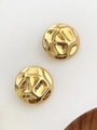 Macro shot of gold-plated hollow semi-circle earrings with lava texture on white backdrop - Hammered Texture Gold