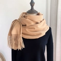 Classic camel faux cashmere scarf with long tassels wrapped on a mannequin model - Light Camel