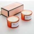 Detailed macro view of handmade orange frosted glass aromatherapy candles with cotton wick - Coral Orange - Orange Blossom