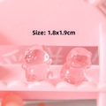 Macro detail of cute translucent pink resin mini pig figurines measuring 1.8x1.9cm - Transparent Pink Pig