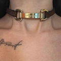Close-up of a brown leather choker featuring a gold horsebit metal plate with engraving - Metallic Gold Leather Necklace X3958B
