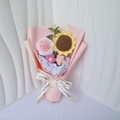 Close-up of handmade crochet sunflower and rose bouquet in pink wrapping with a ribbon - Handmade Crochet Bouquet / Pink