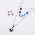 Detailed view of silver stainless steel jewelry set with blue evil eye pendant and studs - Blue & Silver
