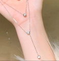 Detail of a minimalist double-layered titanium steel necklace with sparkling crystal charms - Silver