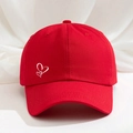 Detailed close-up of a red cotton baseball cap featuring white double heart embroidery - Red