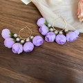 Detailed close-up of purple fabric rose hoop earrings with pearls on a dark wood background - 58# Silver Pin-Purple
