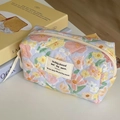 Detail showing the floral quilted makeup bag with soft pastel flowers and zipper closure - Oil Painting Floral (Octagonal Bag)