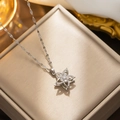 Sparkling silver rotating flower pendant necklace on gold velvet jewelry box - Rotating Five-Petal Flower (592) / Silver
