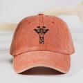 Detailed close-up of embroidered giraffe on rust red washed cotton baseball cap - One Size / Orange