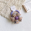 Detail of floral fabric hair scrunchie with purple elastic band and small flower patterns - Purple Floral