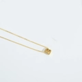 Macro detail of a dainty gold necklace featuring a minimalist letter B initial pendant - Letter B