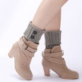 Grey cable knit leg warmers with black button accents on a model wearing beige boots - One Size / Light Gray