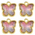 Macro detail of pink butterfly charms with gold metal frames and faceted resin centers - Pink Orange Gradient