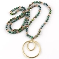 Detailed close-up of beaded necklace with green marble beads and gold double ring pendant - Green Dark Blue Series / Golden Double Ring